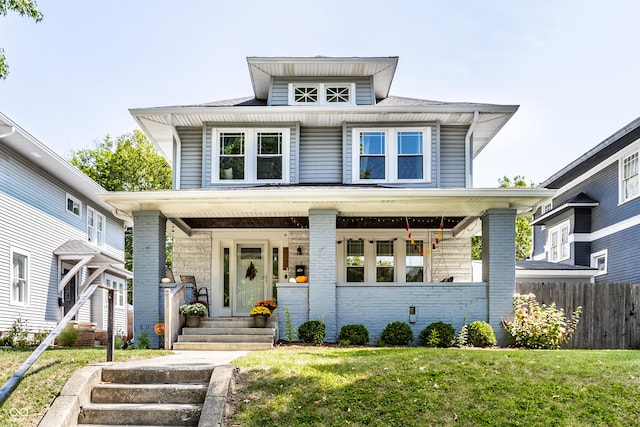 view of front of home featuring a porch and a front lawn