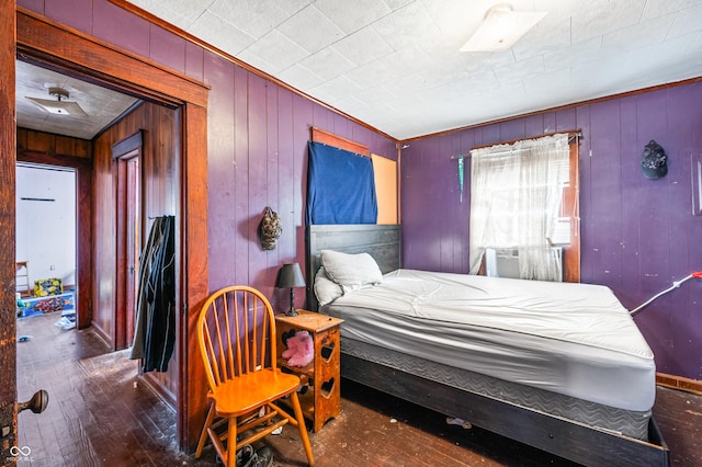 bedroom with cooling unit and dark wood-type flooring