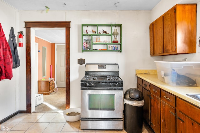 kitchen featuring light tile patterned flooring and gas stove