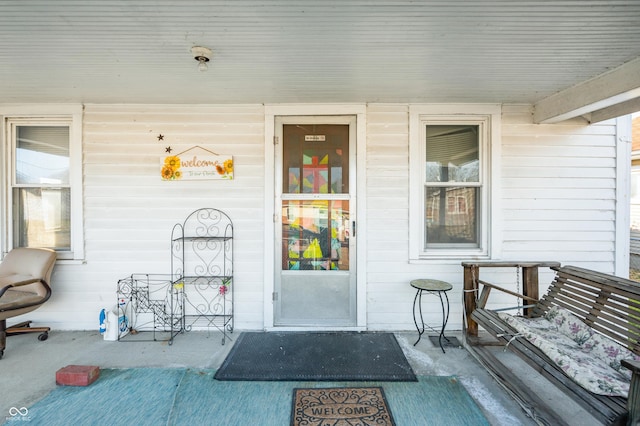 view of exterior entry featuring a porch