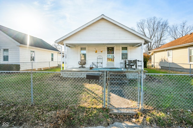 bungalow-style home featuring a front lawn and a porch