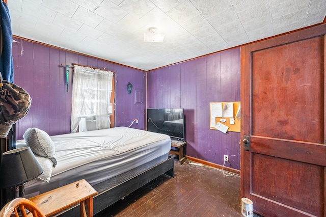 bedroom featuring cooling unit and dark hardwood / wood-style flooring