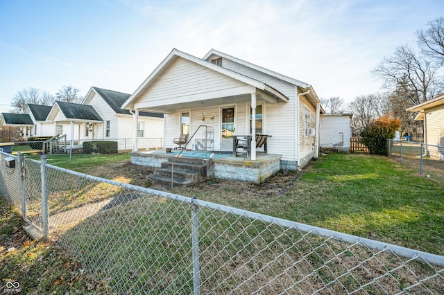 bungalow with a front yard and covered porch