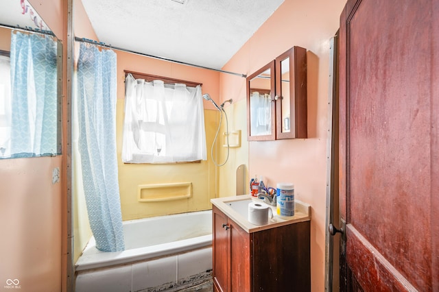 bathroom featuring vanity, shower / bath combination with curtain, and a textured ceiling