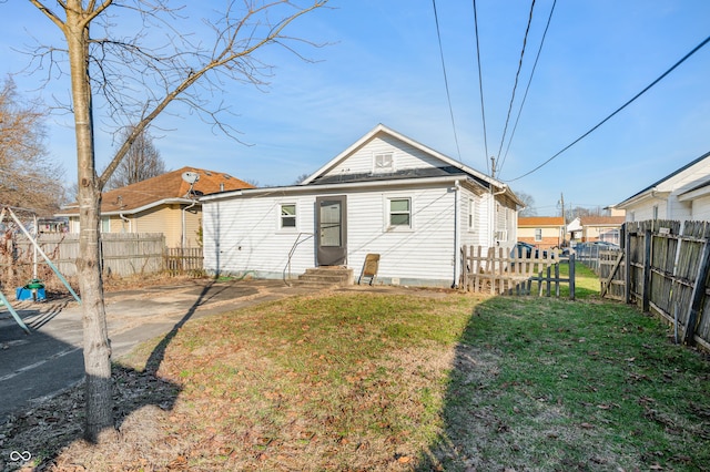 back of property featuring a lawn