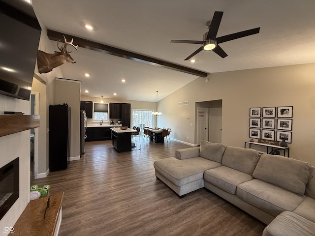 living room featuring dark hardwood / wood-style flooring, sink, lofted ceiling with beams, and ceiling fan