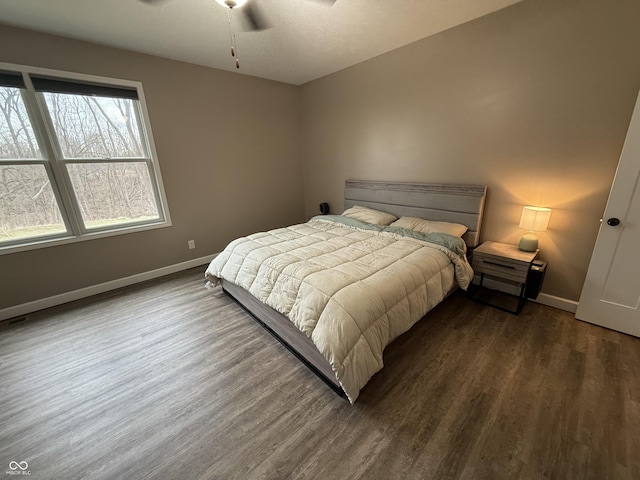 bedroom with dark wood-type flooring and ceiling fan