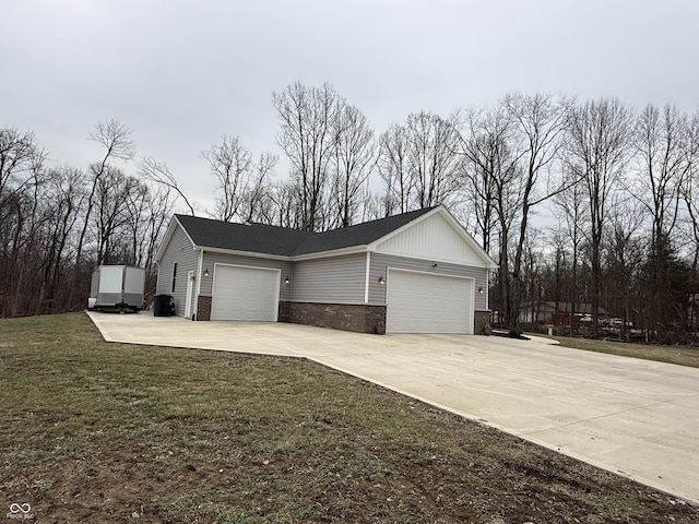 view of side of property with a garage and a lawn