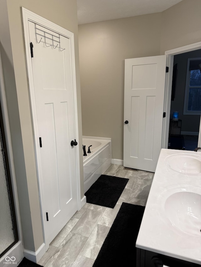 bathroom featuring vanity and a tub to relax in