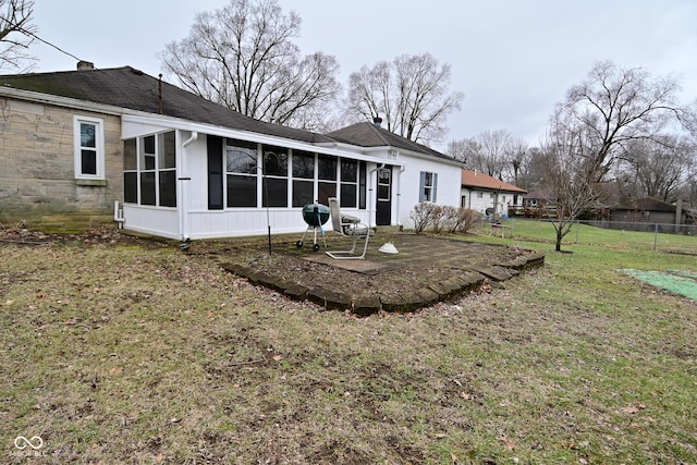 back of house with a yard and a sunroom