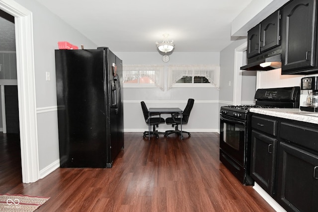 kitchen featuring black appliances and dark hardwood / wood-style floors