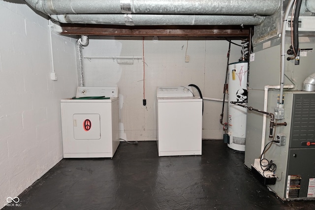 washroom featuring water heater and washing machine and dryer