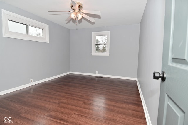 unfurnished room featuring ceiling fan, a healthy amount of sunlight, and dark hardwood / wood-style floors