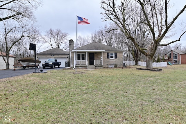 view of front of property with a garage, a front yard, and covered porch