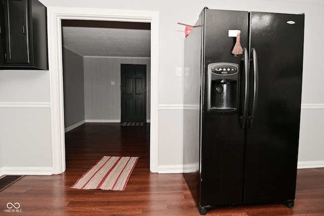 corridor with crown molding, dark hardwood / wood-style flooring, and a textured ceiling