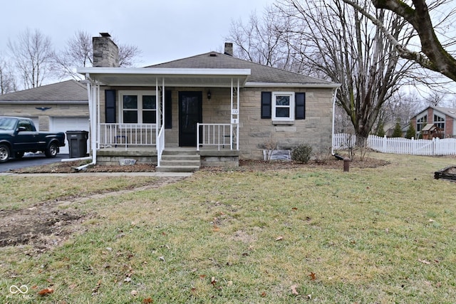 view of front of house with a garage, a front lawn, and a porch