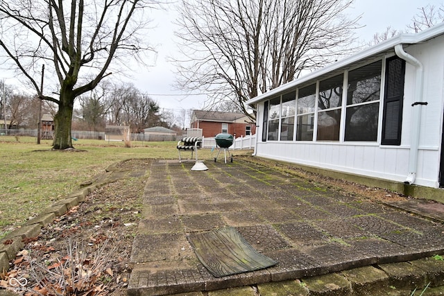 view of yard featuring a sunroom and a patio