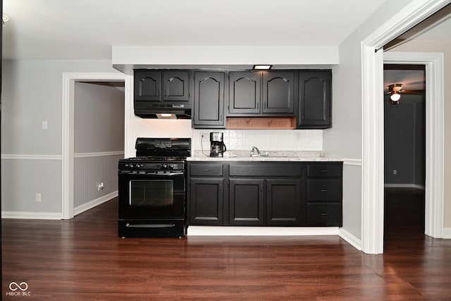 kitchen featuring sink, decorative backsplash, dark wood-type flooring, and black gas stove