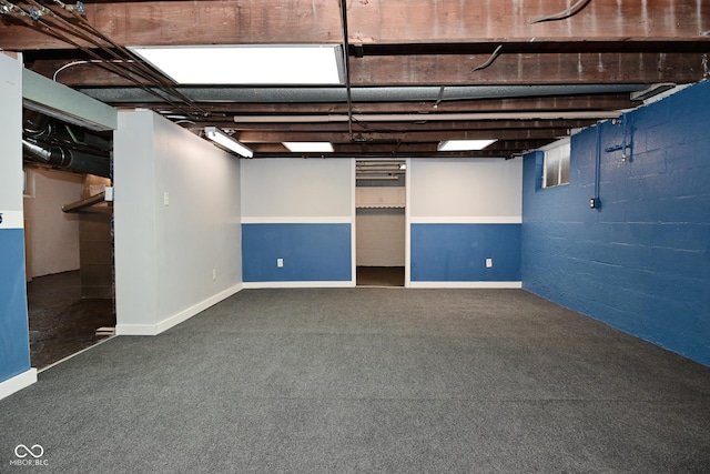 basement featuring dark colored carpet