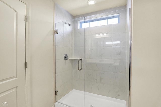 bathroom featuring a shower with shower door