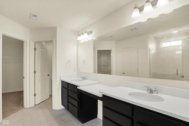 bathroom with vanity and a shower