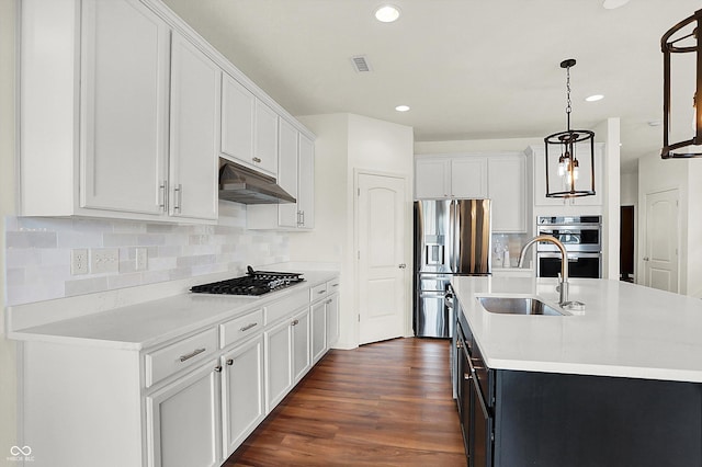 kitchen with sink, decorative light fixtures, white cabinets, and appliances with stainless steel finishes