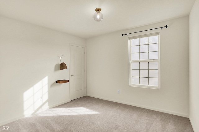 spare room featuring light colored carpet