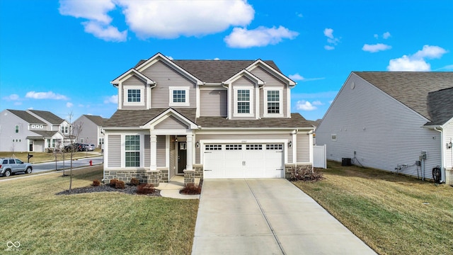 view of front of home featuring a garage, central AC, and a front yard