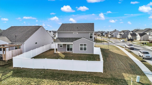 back of house with a lawn