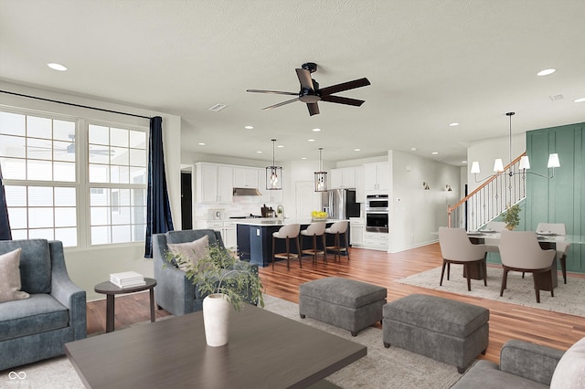 living room with hardwood / wood-style floors and ceiling fan