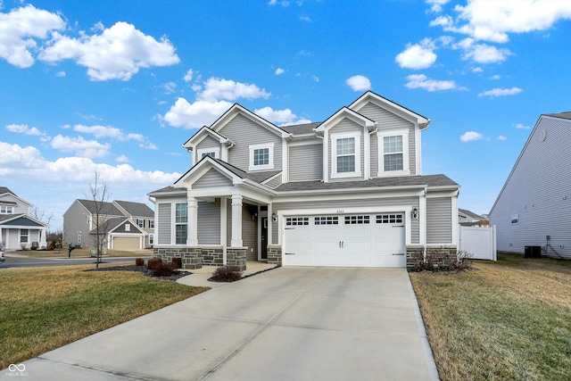 view of front facade featuring a garage, central AC unit, and a front yard