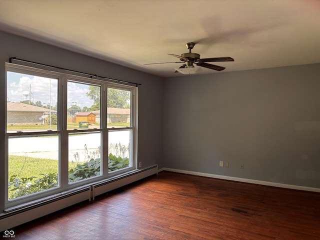 79 Circle Dr, Mooresville, IN 46158 - empty room featuring a baseboard heating unit, dark wood-style flooring, and a ceiling fan