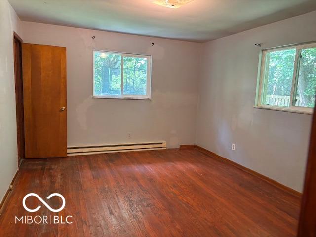79 Circle Dr, Mooresville, IN 46158 - spare room with baseboard heating and wood finished floors