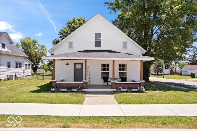 view of front of property featuring central AC unit, covered porch, and a front lawn