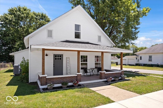 view of front of property featuring a front lawn, covered porch, and central air condition unit