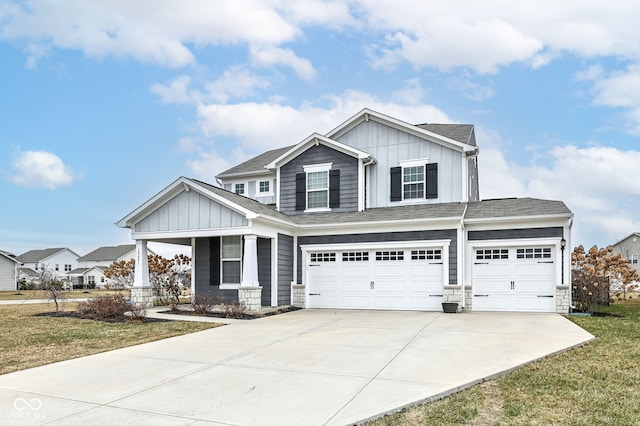 craftsman house featuring a garage, a front yard, and covered porch