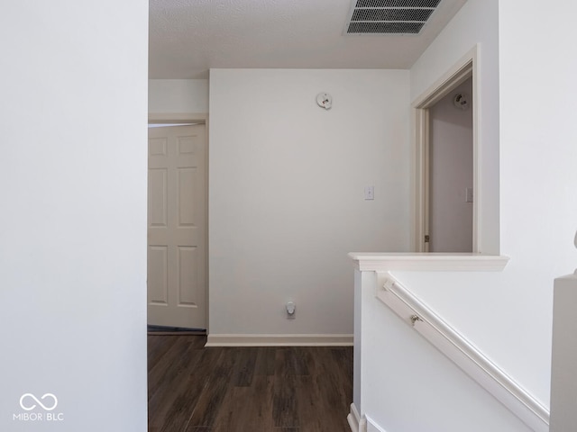 corridor featuring dark wood-type flooring