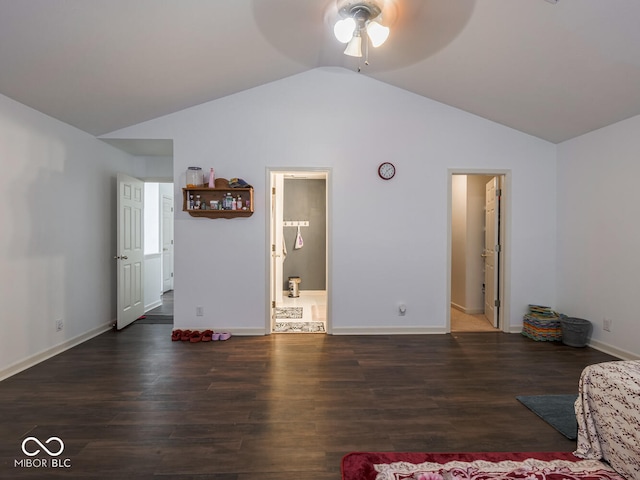 unfurnished bedroom with vaulted ceiling, dark hardwood / wood-style floors, and ensuite bath