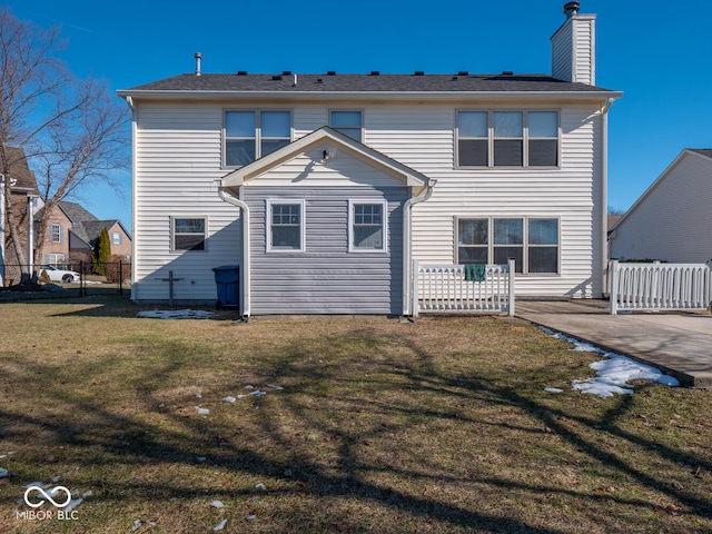 back of house featuring a lawn