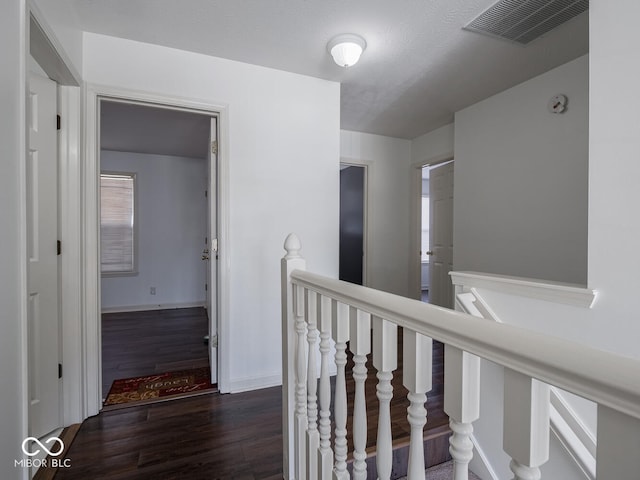 hallway with dark hardwood / wood-style flooring