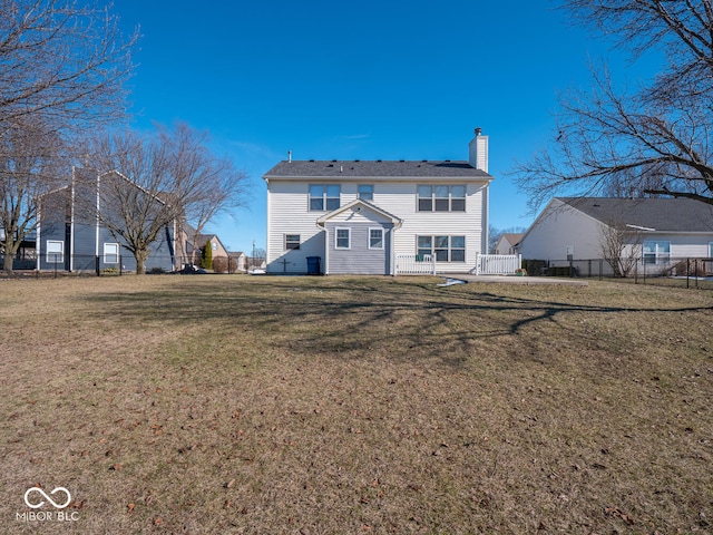 back of house featuring a lawn