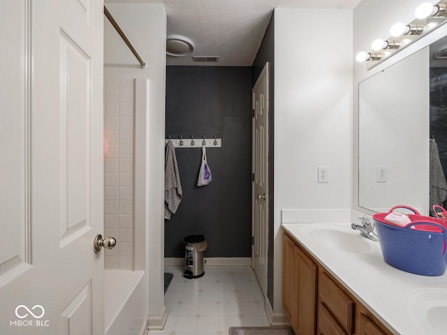 bathroom with vanity and a textured ceiling