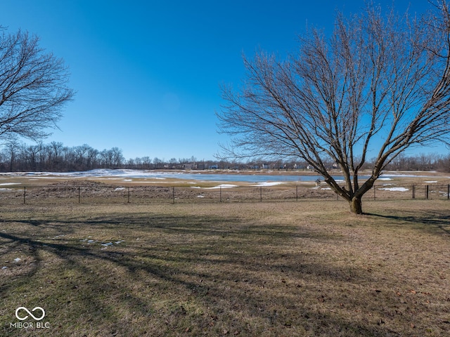 view of yard with a water view and a rural view