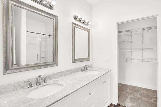 bathroom with vanity and a shower