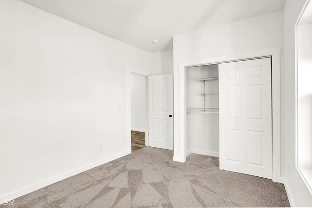 unfurnished bedroom featuring a closet and carpet