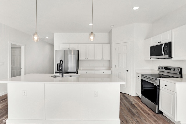 kitchen with sink, a center island with sink, pendant lighting, stainless steel appliances, and white cabinets