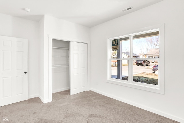 unfurnished bedroom with carpet floors and a closet