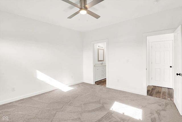 empty room featuring ceiling fan and dark carpet