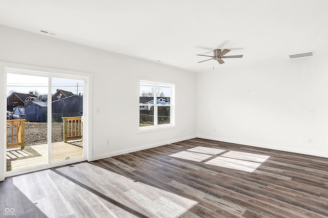 spare room with ceiling fan and dark hardwood / wood-style flooring