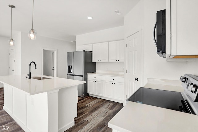 kitchen with pendant lighting, sink, an island with sink, and appliances with stainless steel finishes